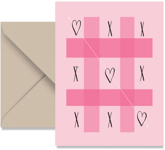 Pink card with tic-tac-toe design and hearts, accompanied by a beige envelope.