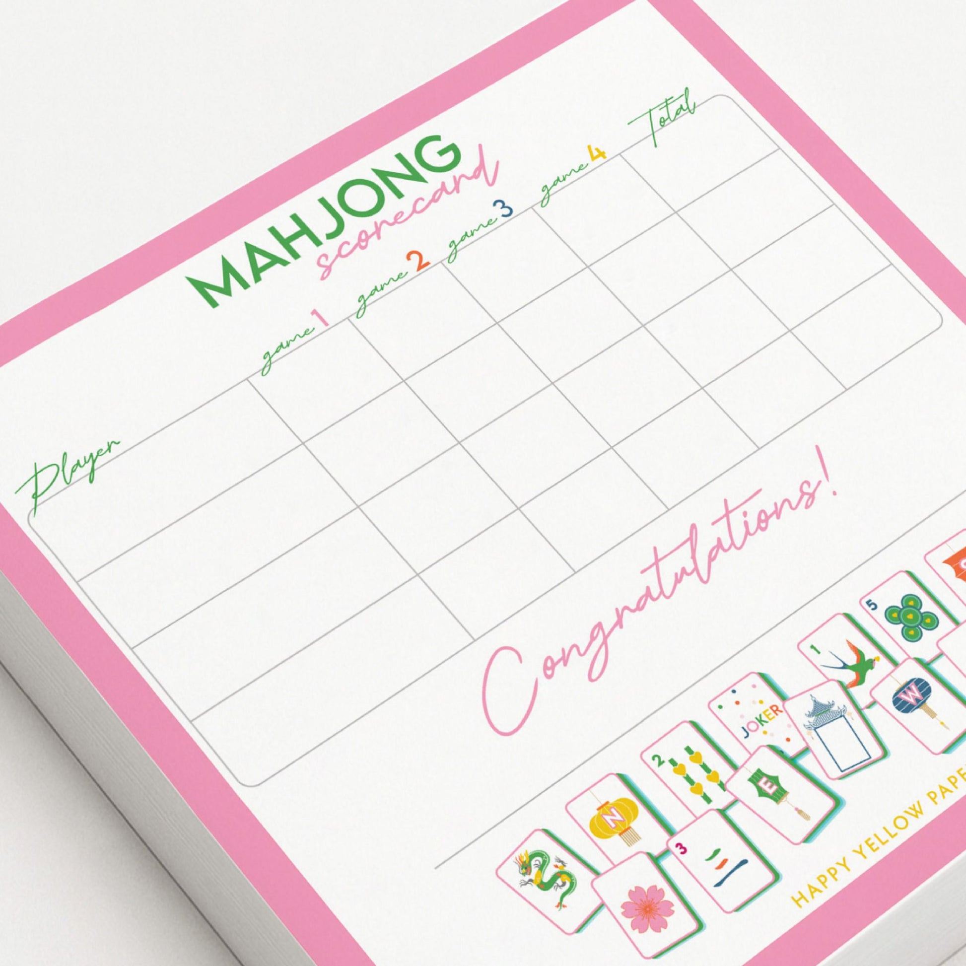 Mahjong scorecard with pink border and game pieces on a white background - Happy Yellow Paper