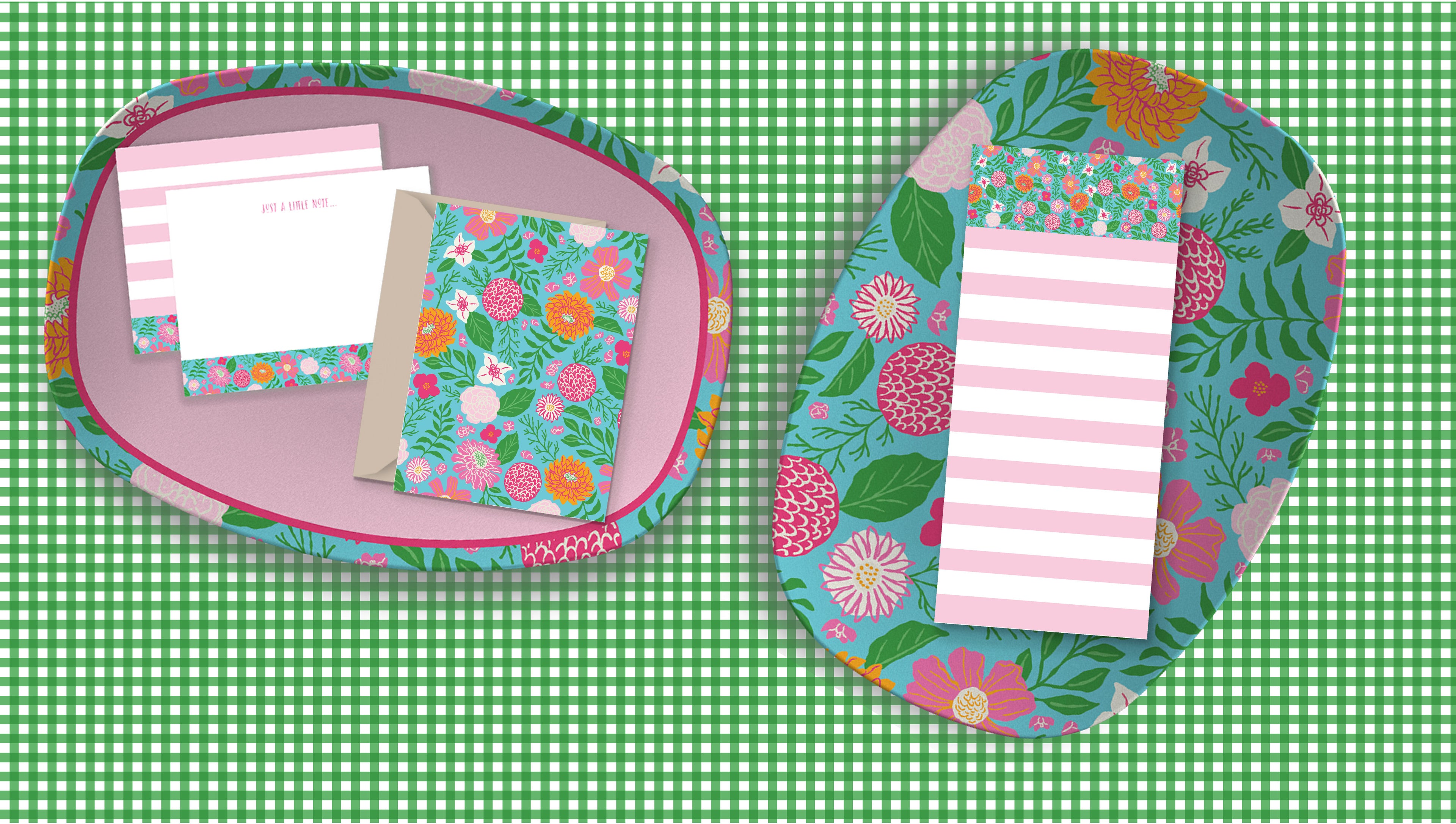 Floral-patterned notepads and envelopes on a green checkered background 
